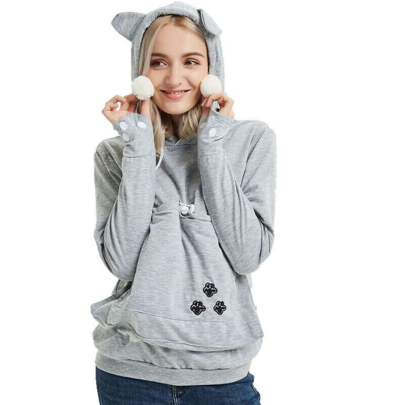 A beautiful young lady is wearing our Silver Gray Cat Pouch Hoodie 